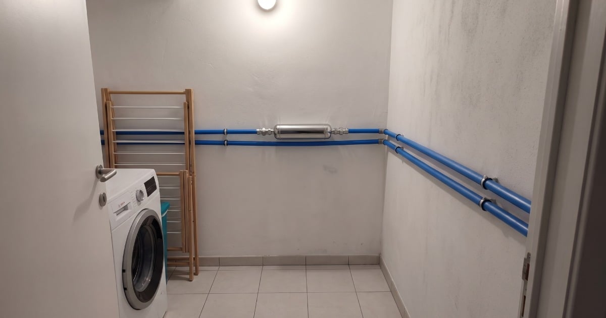 Adoucisseur d'eau sans évacuation dans un local technique d'une habitation.