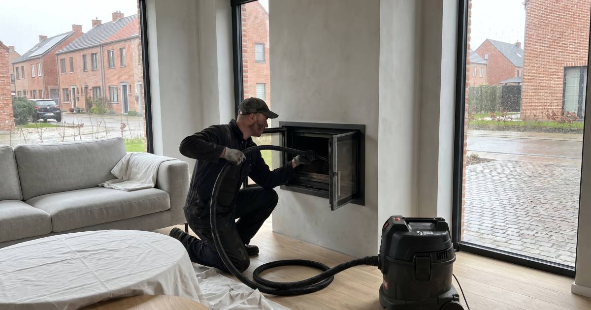 Un ramoneur qui aspire l'intérieur d'une cheminée.