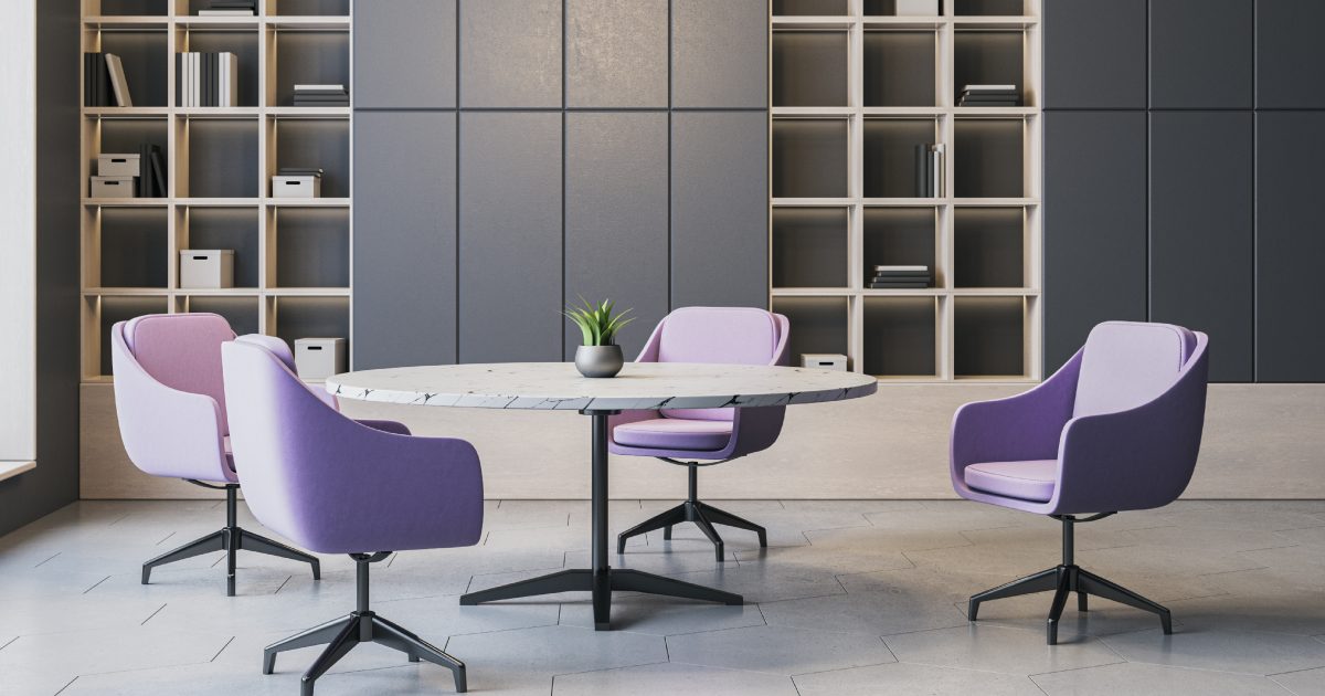 Intérieur de bureau contemporain avec chaises violettes autour d'une table ronde, étagères et armoires sur mur, grande fenêtre avec vue sur la ville.