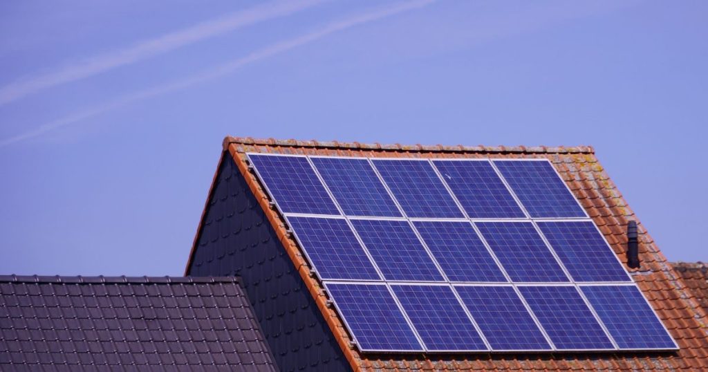 Dak met zonnepanelen op een Vlaamse woning bij helder weer
