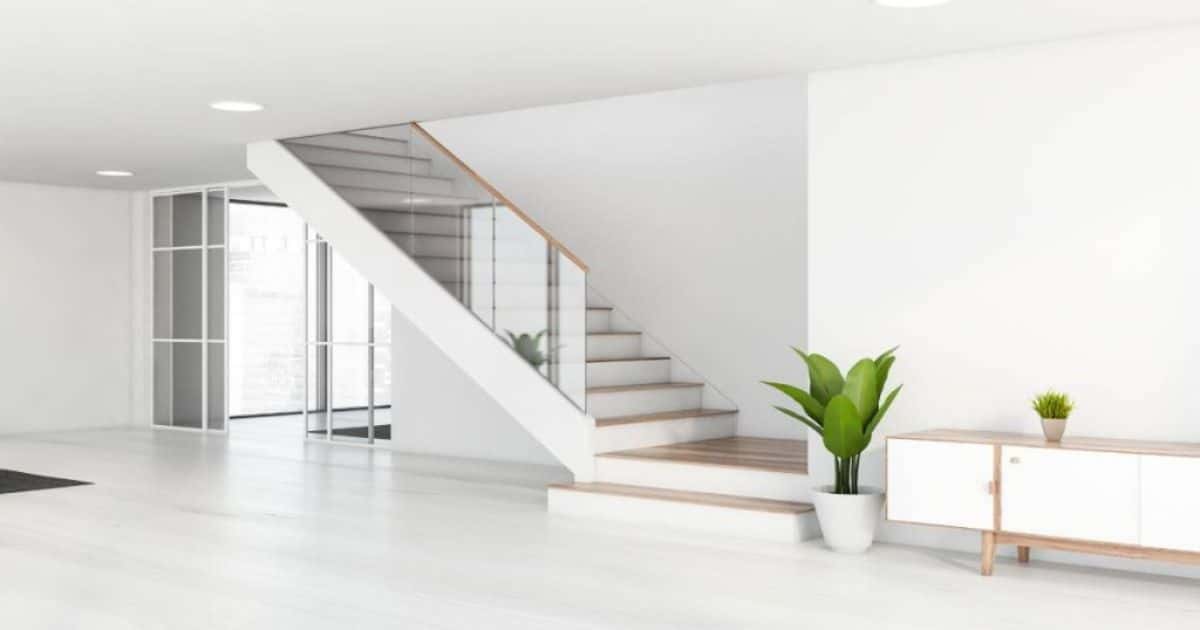 Een houten trap met onderkwart slag in een moderne woning met vrij wit interieur en lichte houtaccenten.