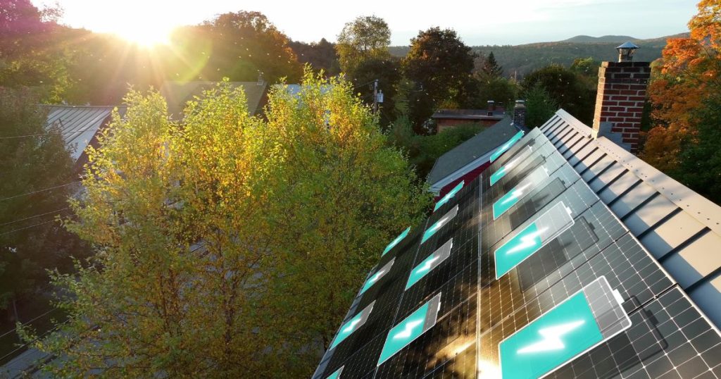 Huis met zonnepanelen bij zonsondergang. Geanimeerde batterij-iconen.