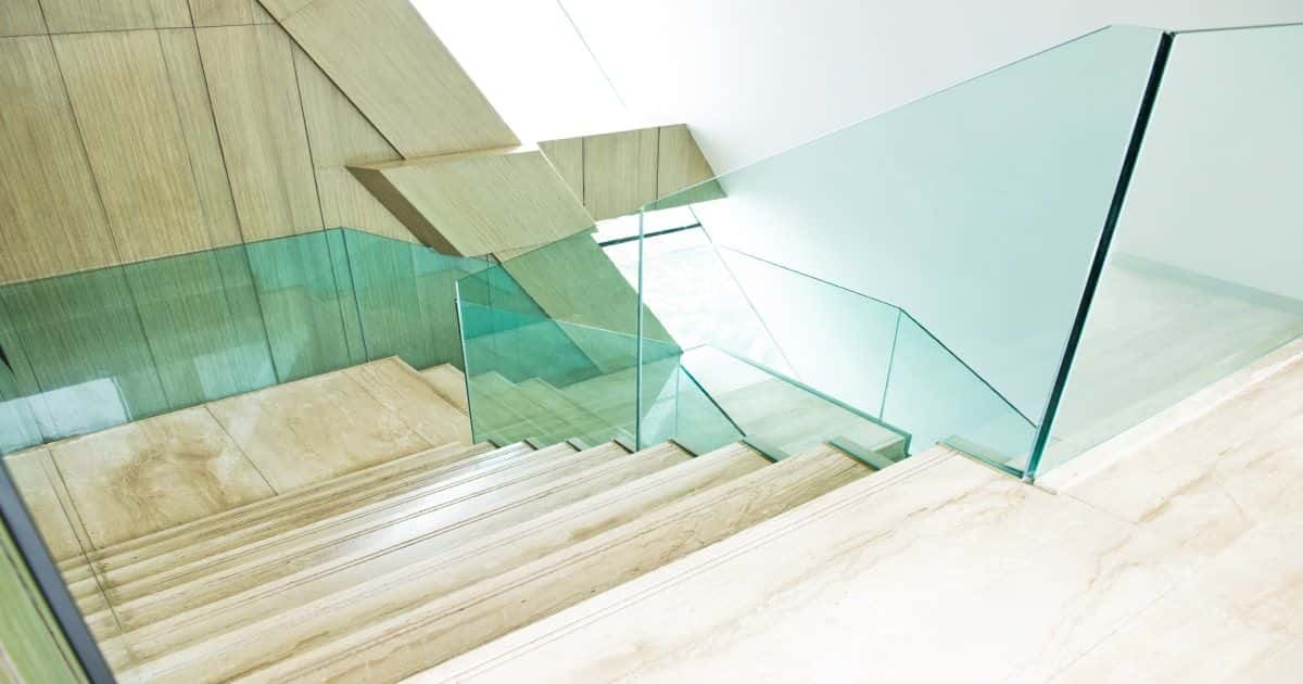 Moderne lange trap met een glazen balustrade 